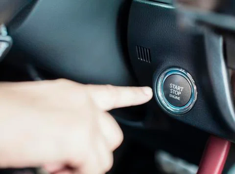 Finger and Engine start stop button in the car Stock Photos