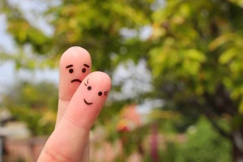 Finger art of couple. Woman is cheerful, man is sad. Stock Photos