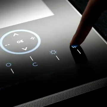 Finger on a black touch screen Stock Photos