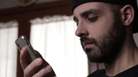 Finger of bored man scrolls page app on mobile phone. Side view Stock Footage 168083153