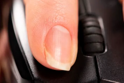 Finger click on the computer mouse. Macro Stock Photos