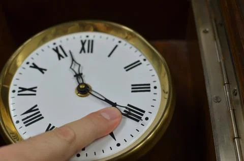 Finger on a Clock Hand Stock Photos