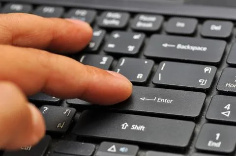 Finger on computer keyboard Stock Photos