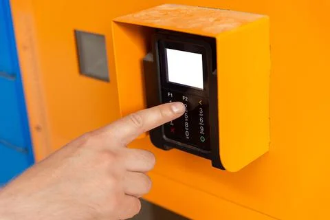 Finger dials pin code on terminal. Stock Photos