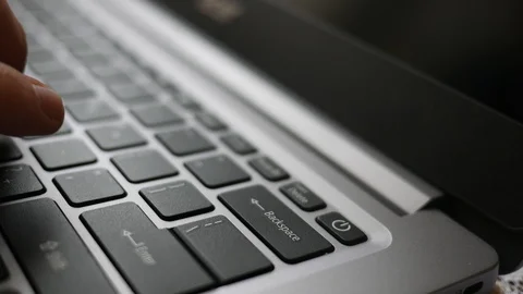 Finger dramatically presses the backspace button on laptop Stock Footage 107243599