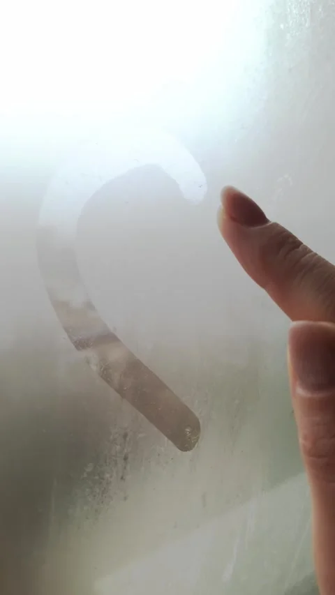 Finger Drawing Heart Shape on Condensed Glass Window Stock Footage 325217014