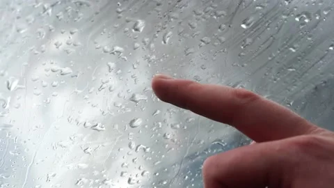 Finger draws a question mark on the sweaty glass on a rainy day Stock Footage 130211097