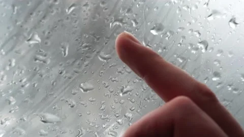 Finger draws a question mark on the sweaty glass on a rainy day Stock Footage 130211103