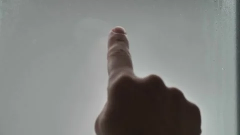 Finger draws a question mark on the sweaty glass on a rainy day background. Stock Footage 241602096