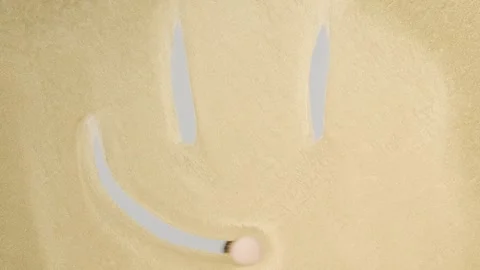 Finger draws a smiley face on a golden background Stock Footage 278048166