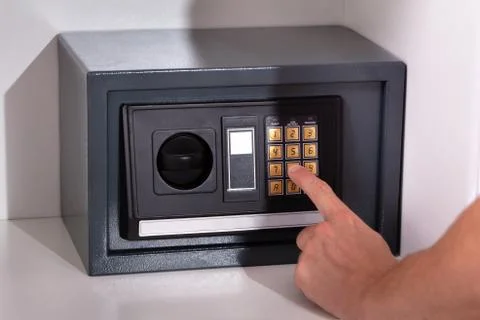 Finger Entering Code In Safety Locker Stock Photos
