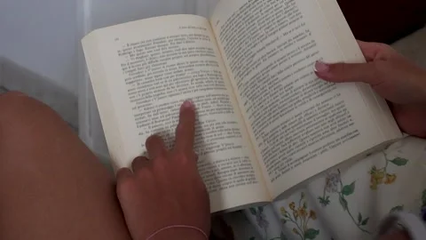 Finger Following Text While Reading an Open Book Indoors Stock Footage 344208283