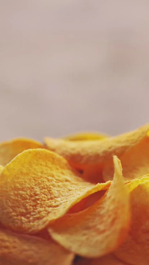 Finger Food Chips Rotating in Macro Frame with Salted Texture Vertical Video Stock Footage 316560185