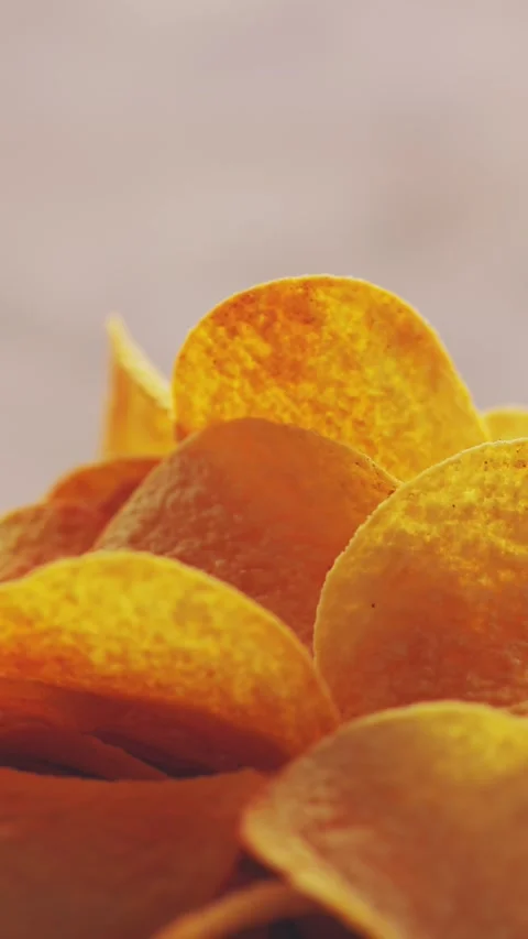 Finger Food Chips Rotating in Macro Frame with Salted Texture Vertical Video Stock Footage 316560222