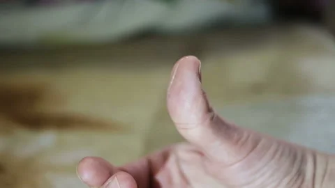 On the finger of the hand is a small transparent worm. Worm pulled from salted m Stock Footage 102140273