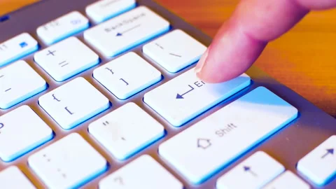Finger hitting enter key many times on a keyboard with anger. Stock Footage 145451904
