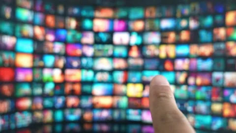 A finger hovers to select content on a vast TV display. Stock Footage 315542544