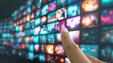A finger hovers to select content on a vast TV display. Stock Footage 315542565