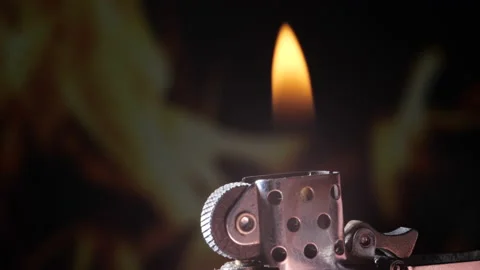 Finger ignites zippo lighter studio shot close up with flaming fire Stock Footage 235659652