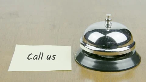 Finger Index Ringing Bell with Call Us Text or Word on Yellow Note Stock Footage 300879616