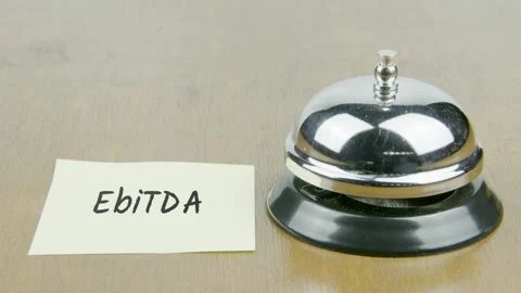 Finger Index Ringing Bell with EbiTDA Text or Word on Yellow Note Paper Stock Footage 300861895