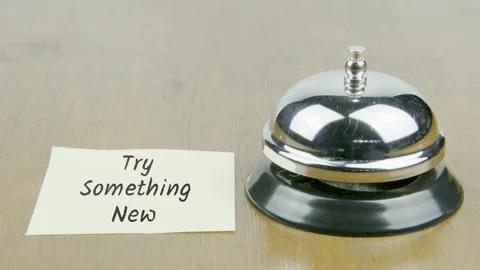 Finger Index Ringing Bell with Try Something New Text or Word on Yellow Note Stock Footage 300882620