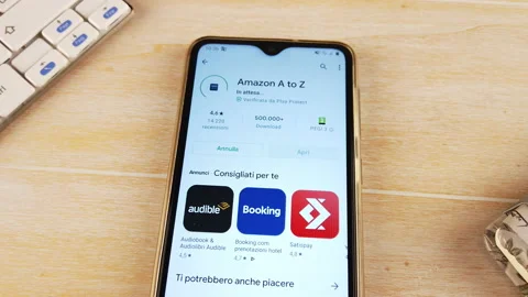 Finger installing the AMAZON A to Z app on the phone Stock Footage 144136475