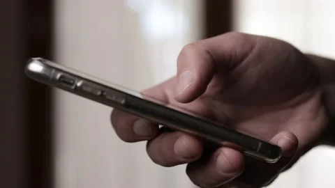 Finger of man touching scroll page app on mobile phone. Browsing internet Stock Footage 168081611