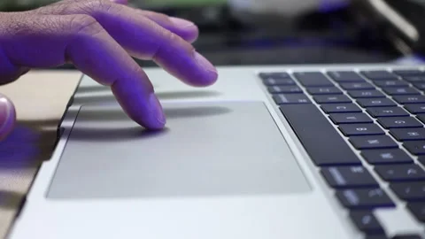 A finger moves the tab cursor on a laptop touchpad Stock Footage 312413549