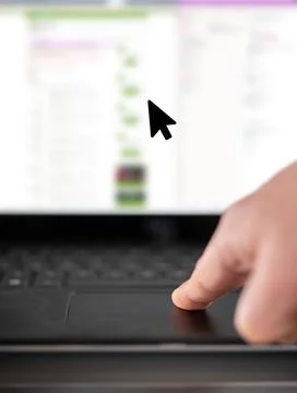 Finger moving mouse pointer on laptop touchpad Stock Photos