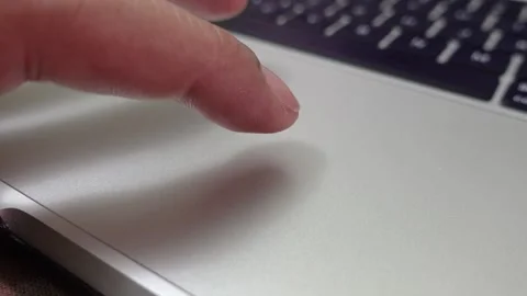 Finger navigating the cursor on a laptop touchpad Stock Footage 312413545