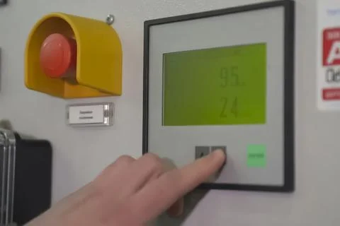 Finger on parameter value adjustment button on the control panel Stock Photos