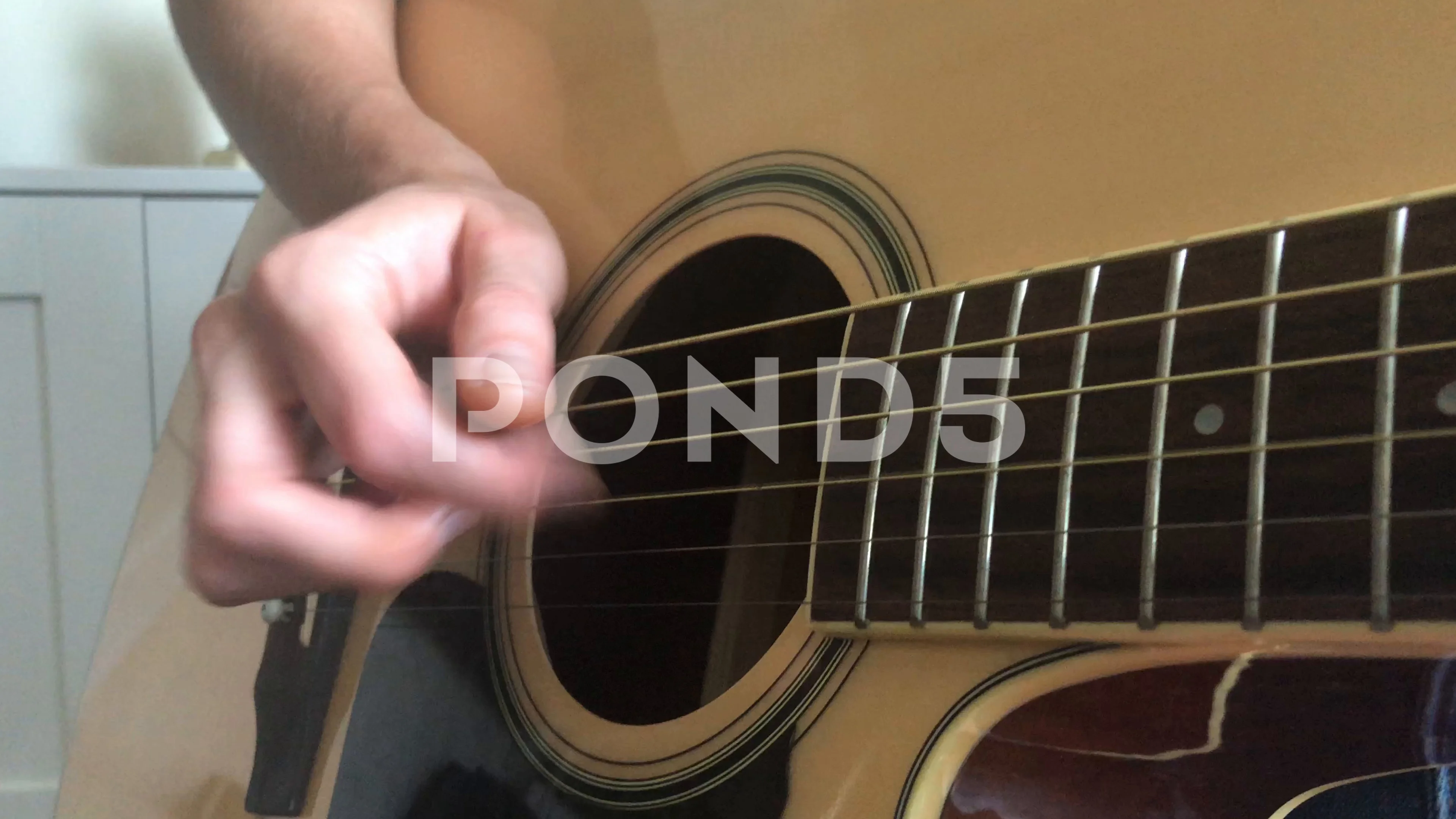 finger picking on the guitar strings trebbling