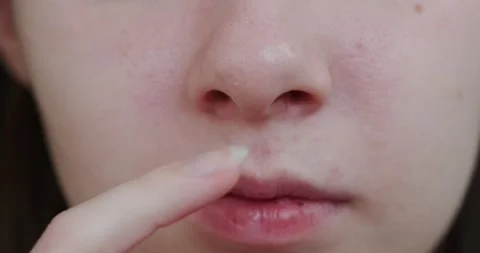 Finger picking her nose Stock Footage 132369711