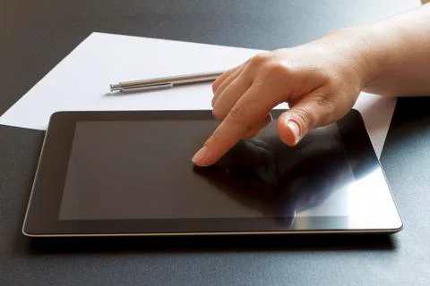 Finger pointing on digital tablet. 스톡 사진