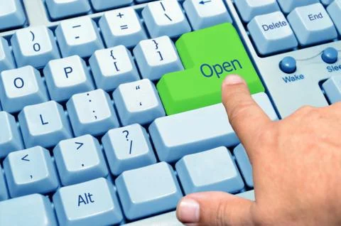 Finger pointing at the green key open Stock Photos