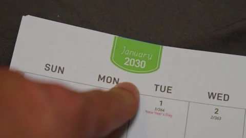 Finger pointing at January 2030 planner page close up for future scheduling and Stock Footage 336486408