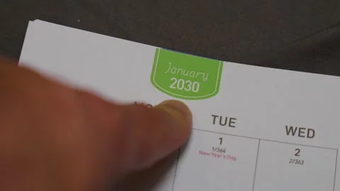 Finger pointing at January 2030 planner page close up for future scheduling and Stock Footage 336486531