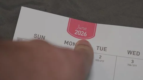 Finger pointing at June 2026 planner page close up for scheduling and monthly Stock Footage 339796188
