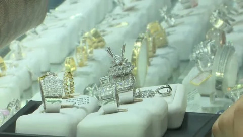 Finger Pointing At Large Diamond Ring In Blurred Showcase Stock Footage 345502585