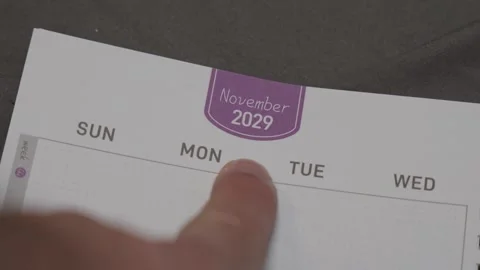 Finger pointing at November 2029 planner page close up for scheduling and Stock Footage 338363053