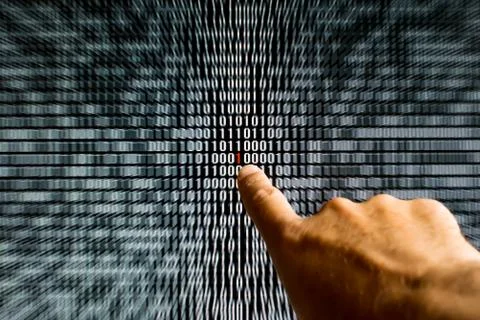 Finger pointing at a red bit in binary code 스톡 사진