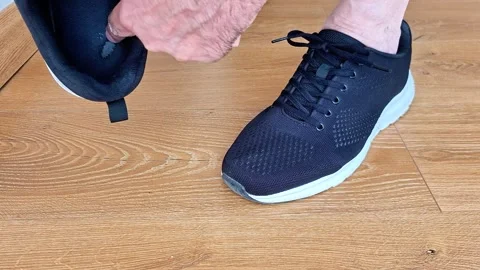Finger Pointing to Worn Out Sneaker Insole for Footwear Detail Vídeos de archivo 343067070