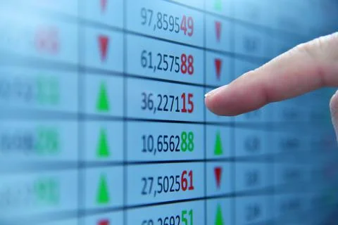 Finger points to financial statistic on computer screen Stock Photos