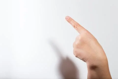 Finger points to the upper left corner Stock Photos