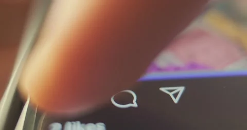 Finger press like button, heart icon on smartphone screen. Macro, close-up 動画素材 229540744