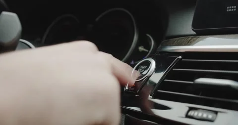 Finger press the button to start the car engine. Close up. Stock Footage 144412636