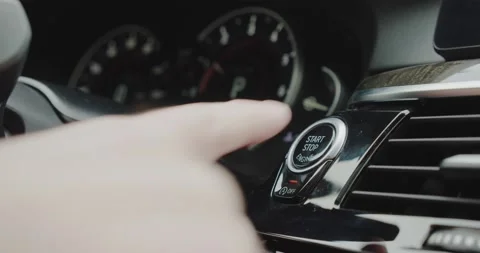 Finger press the button to stop the car engine. Close up. Stock Footage 144506539