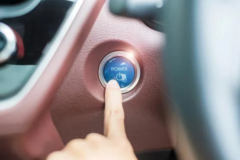 Finger press a car ignition button or START engine inside modern electric a.. Foto stock