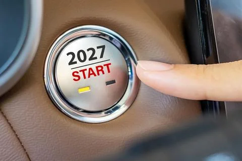 Finger press a car ignition button with 2027 START text inside  automobile... Stock Photos